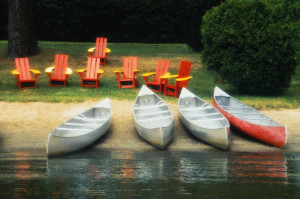 Canoes and Chairs on the Shore of a Lake